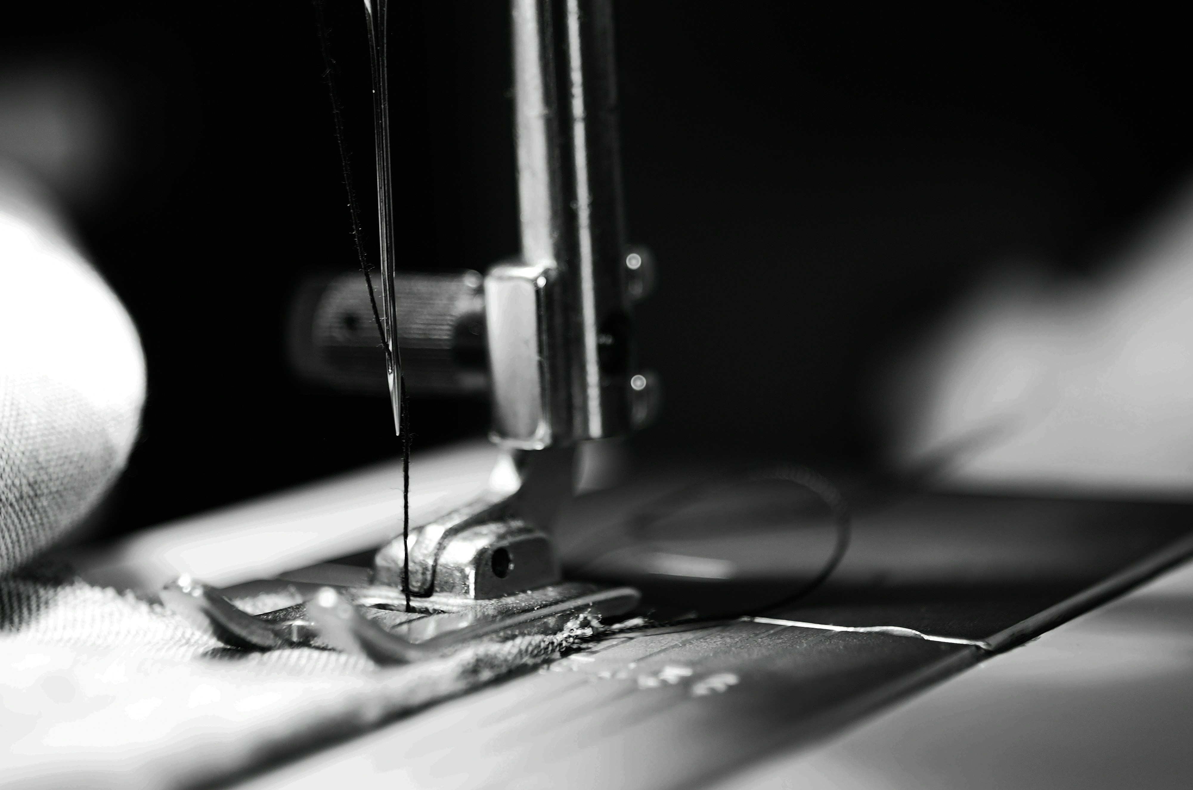 Close-up of hands carefully sewing fabric on a sewing machine